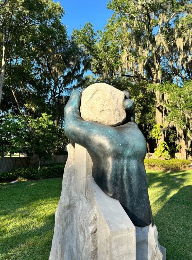 Sculpture art , hand holding a rock with stars painting on the hand at Lake Concord Park - image by Dani Meyering