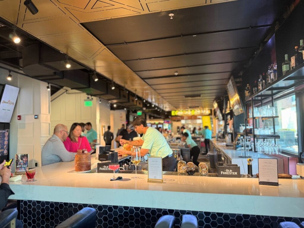 A few adults enjoy the bar of City Food Hall Orlando - image by Jodi Caballero