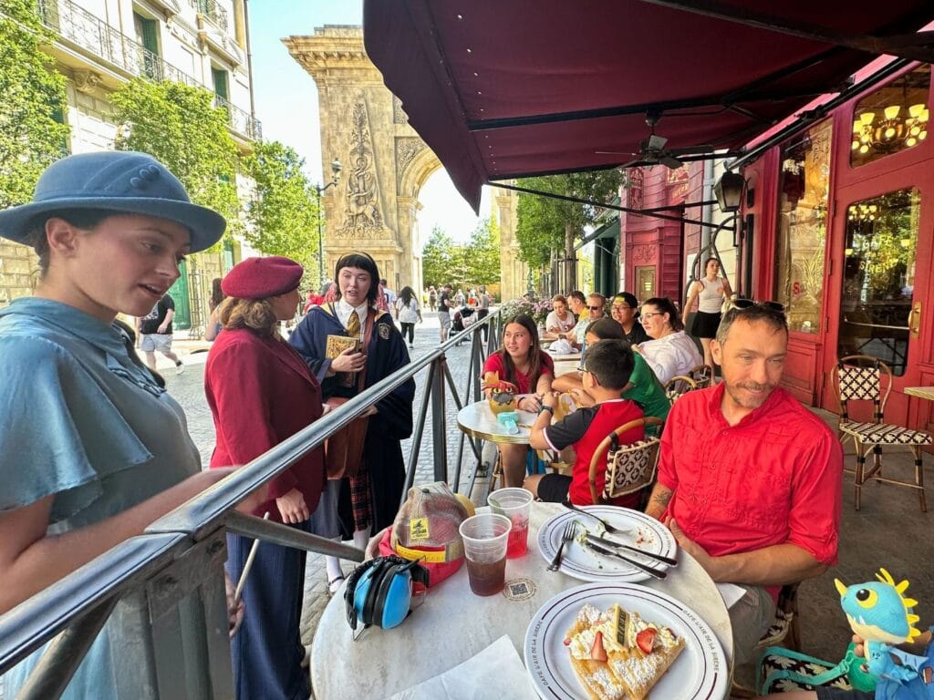 Butterbeer crepe and drinks on table outdoor dining area cafe l'air de la sirene harry potter epic universe - image by Dani Meyering