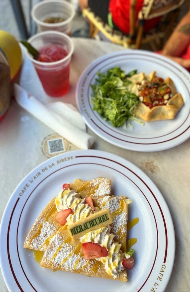 Butterbeer crepe and drinks on table outdoor dining area cafe l'air de la sirene harry potter epic universe - image by Dani Meyering flat lay