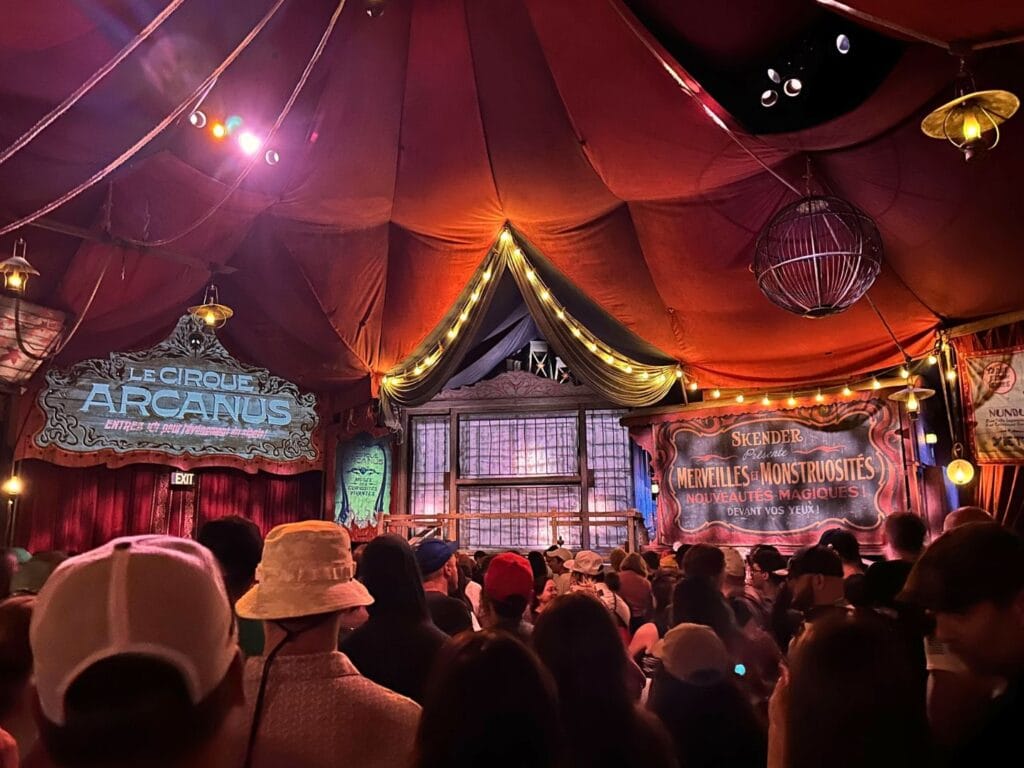 Crowd waits inside Le Cirque Arcanus at Wizarding World of Harry Potter Epic Universe - image by Dani Meyering