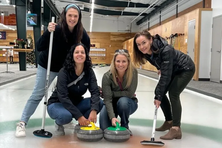 Four female curling players