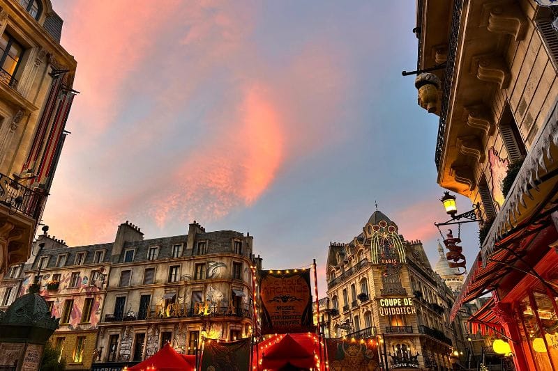 sunset with pink and purple tones among the french inspired buildings of harry potter epic universe - image by Dani Meyering compress
