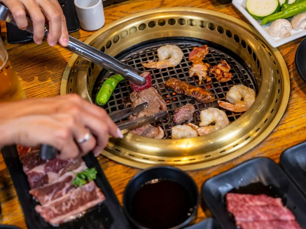 couple cooks Mixed proteins on the grill at Gyu-Kaku Orlando date night