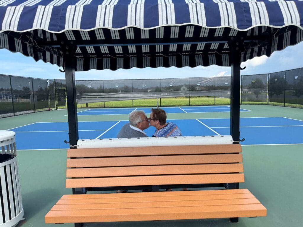 couple kissing on pickleball court