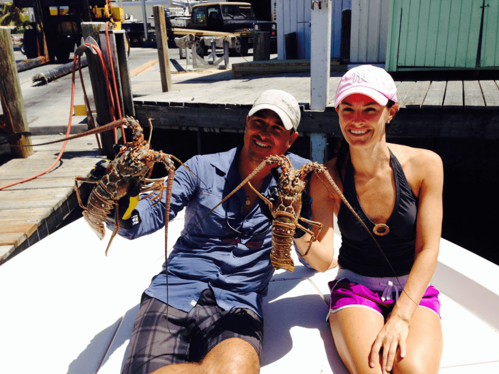 Couple holding spiny lobster in Florida keys