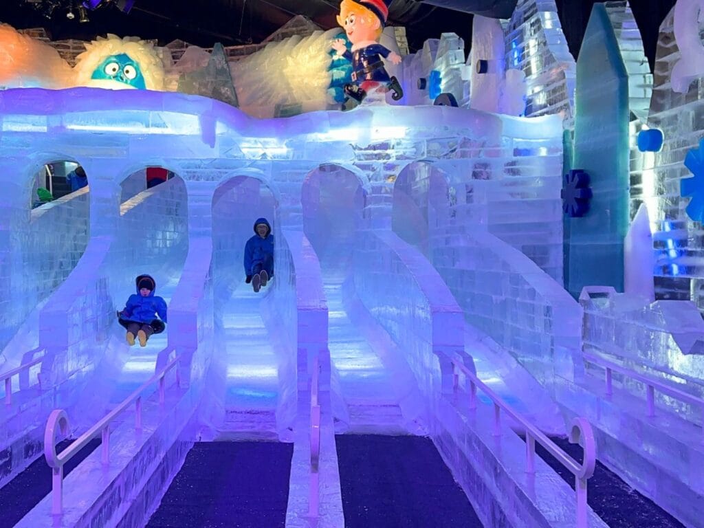 Father and son on ice slides at ICE! Gaylord Palms - image by Dani Meyering