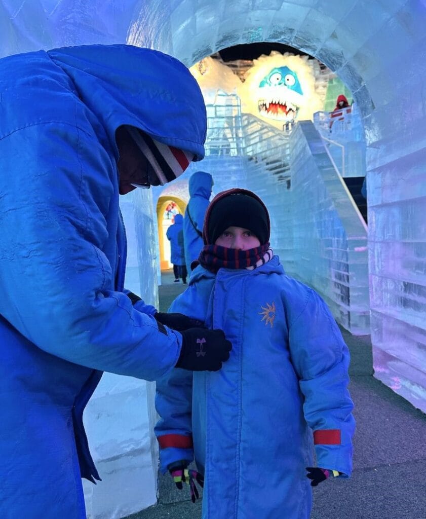 Father bundles up son at ICE! Gaylord Palms - image by Dani Meyering