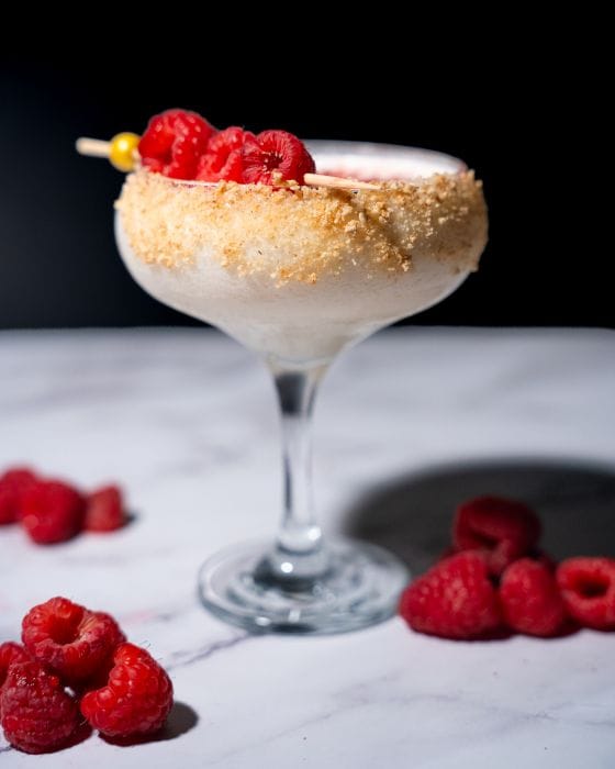A cocktail with raspberries at Delaney's Tavern