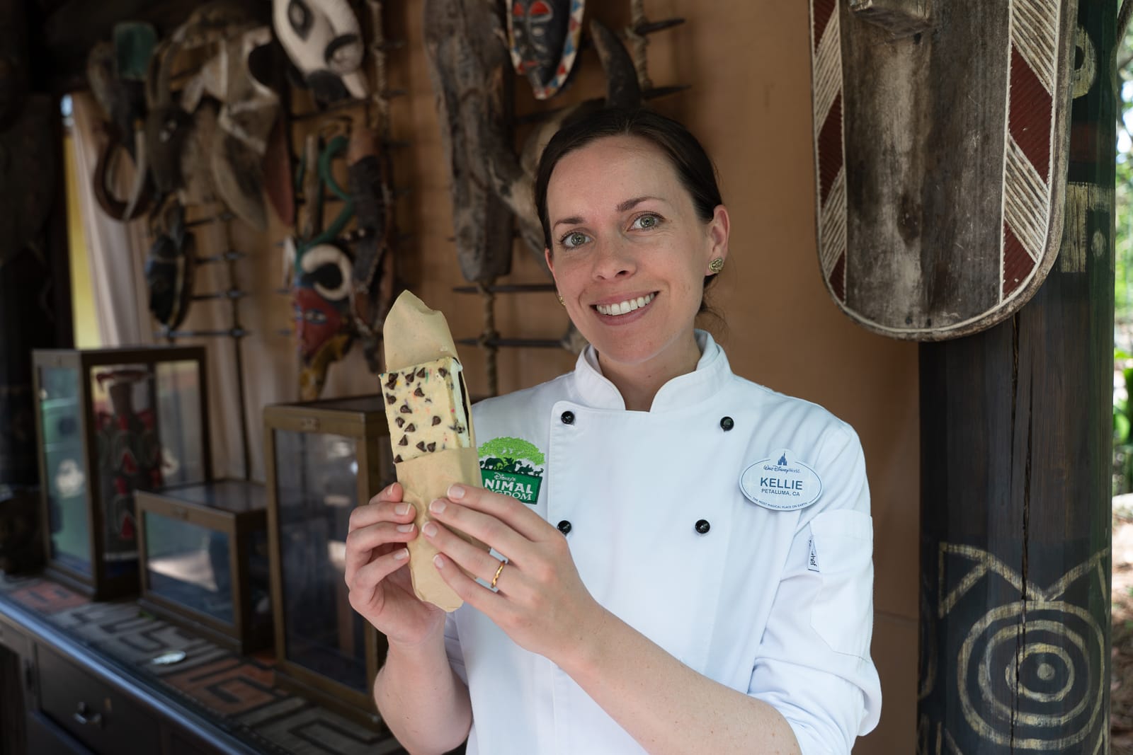 Disney Animal Kingdom Pastry Chef Kellie Matthews holding her viral Cookie Dough Brownie Ice Cream Sandwich