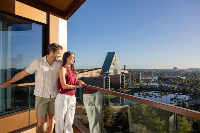 Couple overlooking Swan and Dolphin Resort from a beautiful balcony