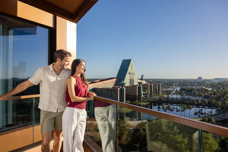 Couple overlooking Swan and Dolphin Resort from a beautiful balcony